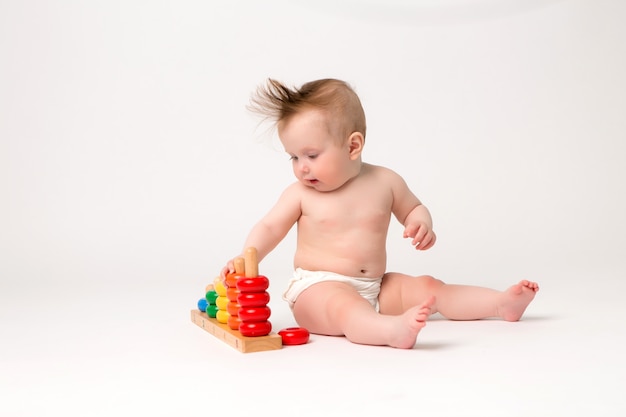 cute baby with developmental toy on a white background