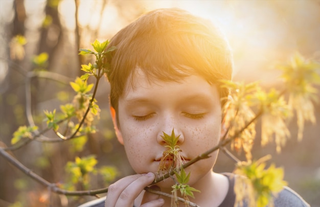 Cute baby with freckles on her face breathes spring fresh air. 