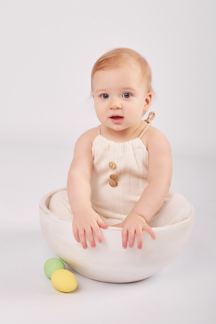 Cute baby with painted Easter eggs