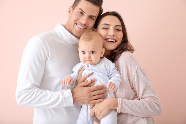 Cute baby with parents on color