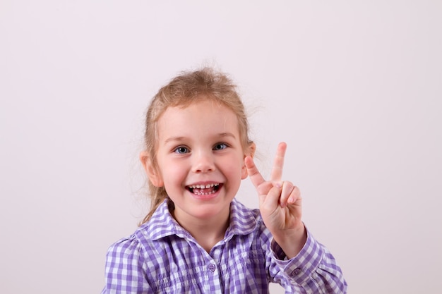 Cute beautiful baby girl showing two fingers