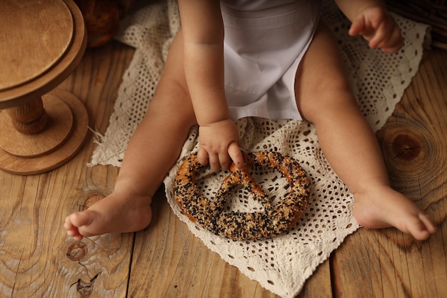 cute blond kid in a chef costume in the frame of the babys arms and legs