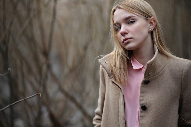 Cute blonde in a city park on a cold sunny day