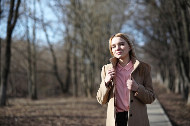 Cute blonde in a city park on a cold sunny day