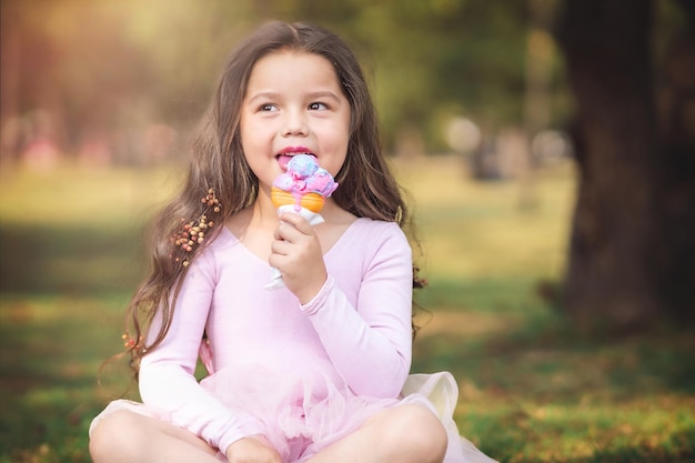 사진 children39s 날의 공원 개념에 좋은 아이스크림을 먹는 귀여운 금발 곱슬 머리 소녀