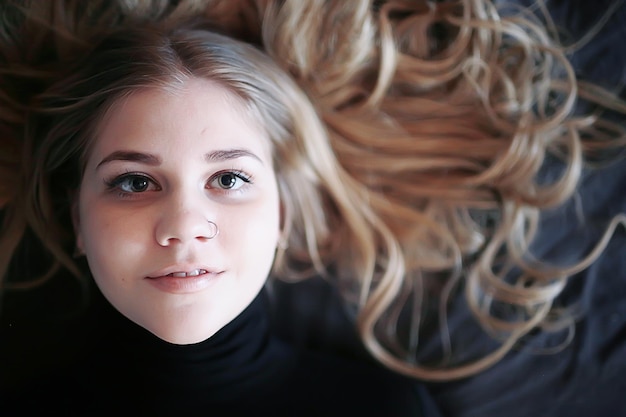 cute blonde sweater portrait / winter look, portrait of beautiful model with long hair in cold season