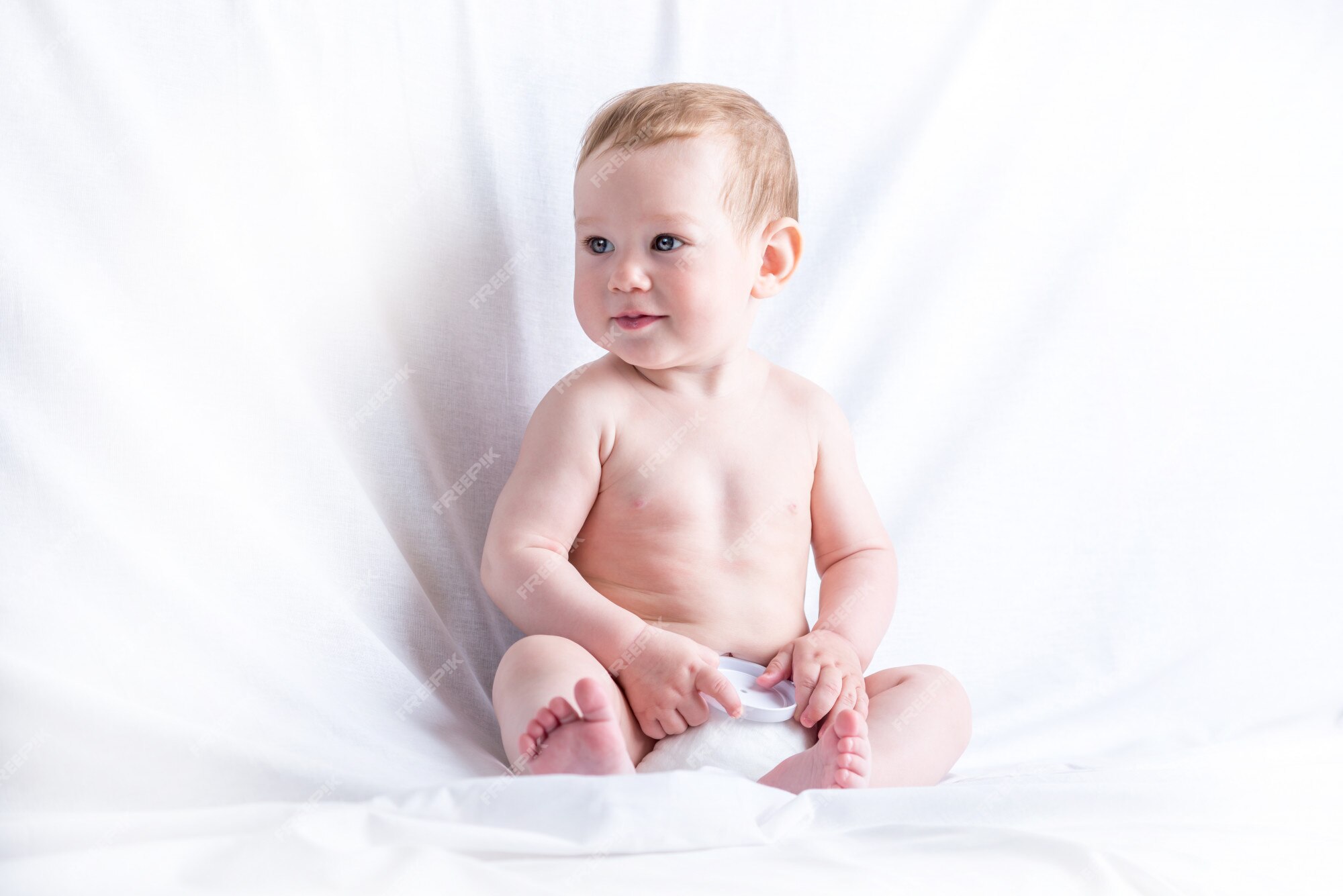 Premium Photo | Cute blue-eyed baby 6-9 months smiling and playing on white  background. children's emotions