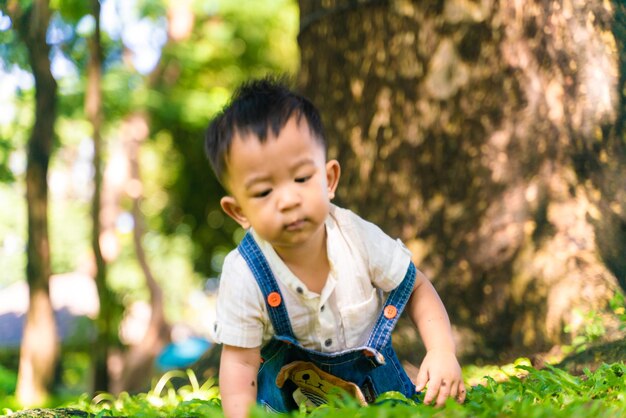 Cute boy against trees