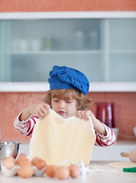 Cute boy baking at home