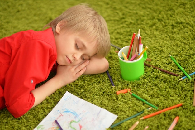 Cute boy drawing with pencils