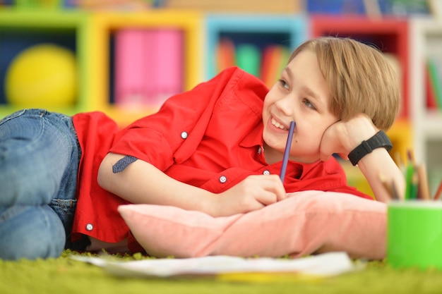 Cute boy drawing with pencils