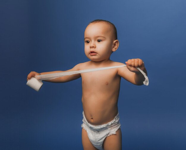 Cute boy holding a medical bandage in his hands.