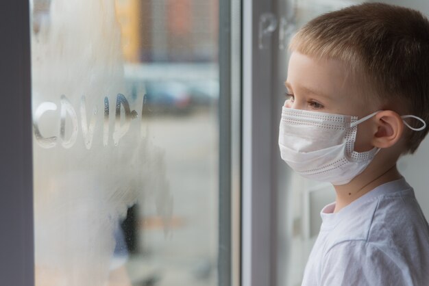 Cute boy looking through the window