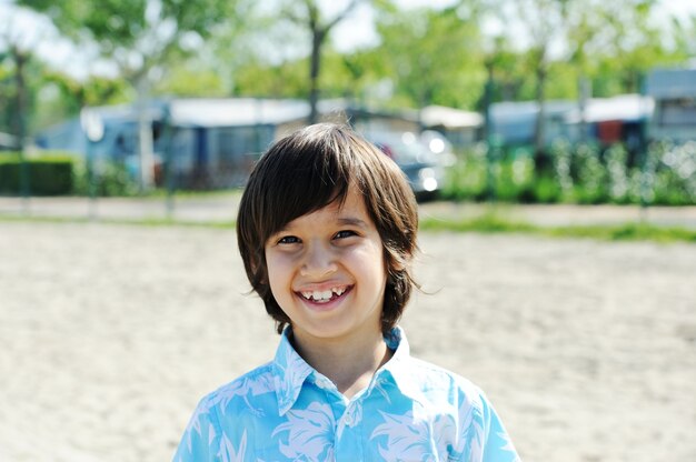 Cute boy in a park on beach