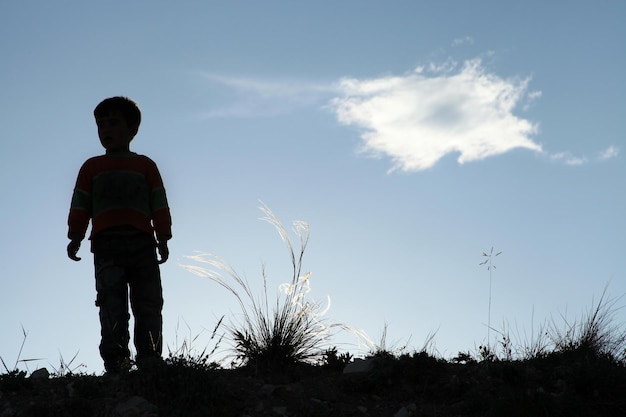 Cute boy playing alone in nature