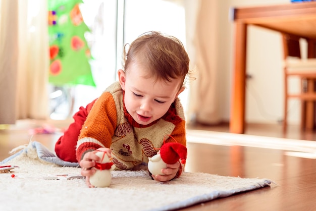 Cute boy playing with toy at home
