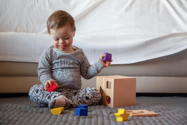 cute boy playing with toys on rug