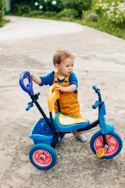 Cute boy riding toy car