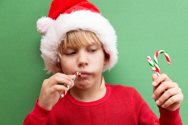 Cute boy in a Santa Claus red hat and a red jacket