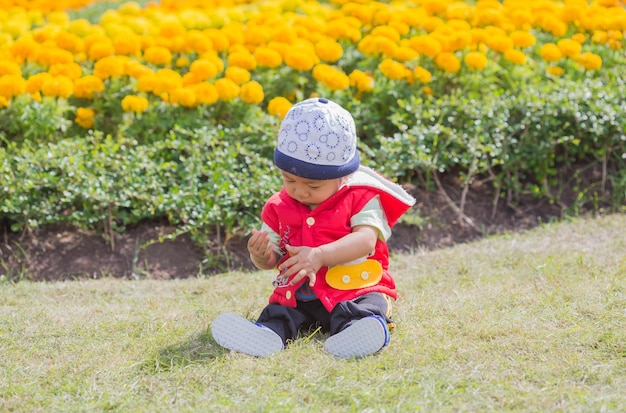 Cute boy sitting on lawn