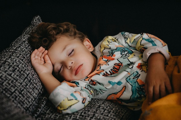 Photo cute boy sleeping at home