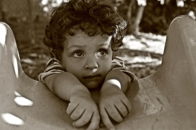 Photo cute boy on slide at playground