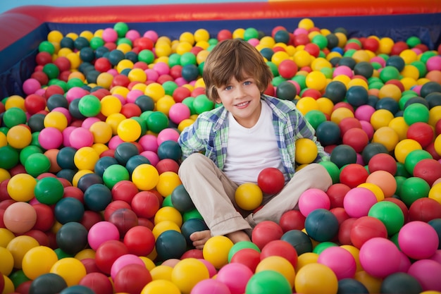 Cute boy smiling in ball pool