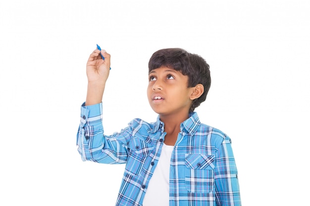 Cute boy smiling and writing