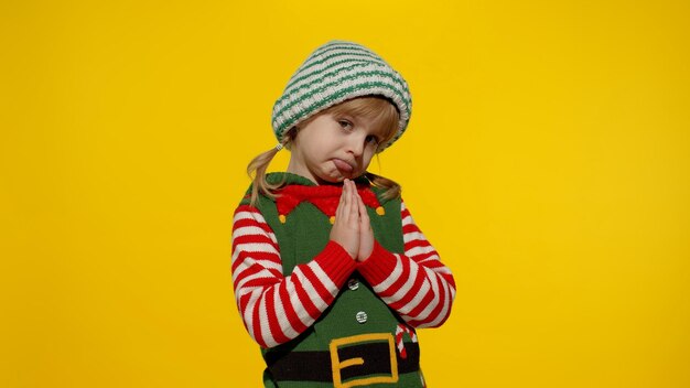 Cute boy standing against yellow background