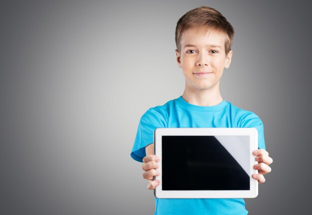 Cute boy with tablet computer in hands