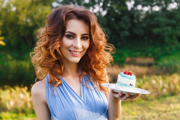 Cute bridesmaid eats wedding cake on the wedding ceremony