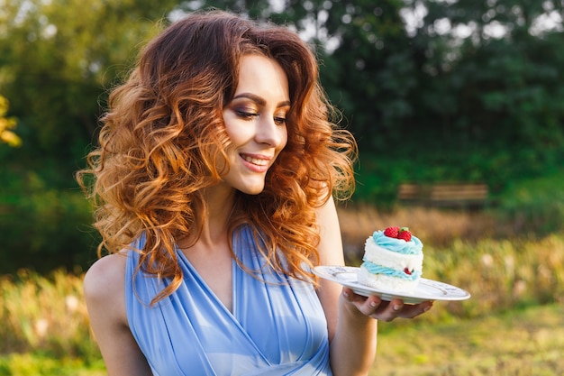 Cute bridesmaid eats wedding cake on the wedding ceremony