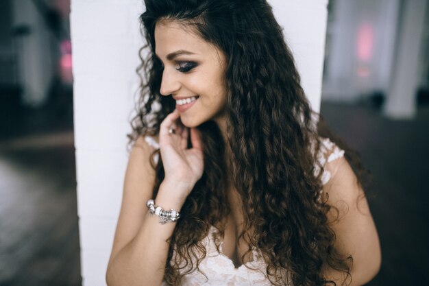 Cute brunette girl with curly hair smiling