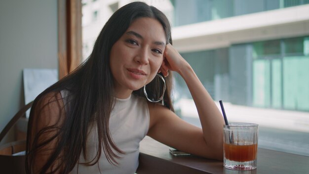 Cute brunette relaxing cafeteria alone close up happy korean woman smiling