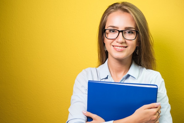 Cute business woman in spectacles holding a folder