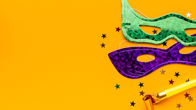 Cute carnival masks on yellow background