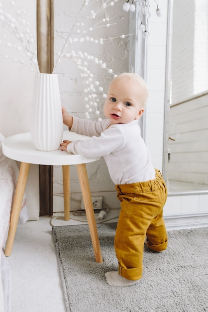 Cute Caucasian baby learning to stand