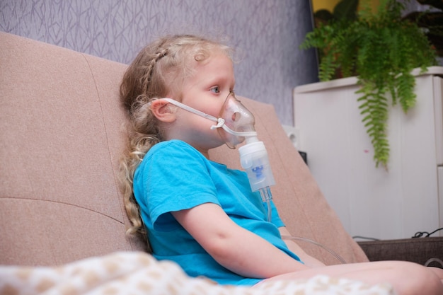 Cute caucasian girl is ignited using a nebulizer