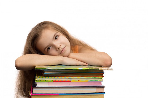 Cute caucasian little girl with books. School portrait. Isolated on white background