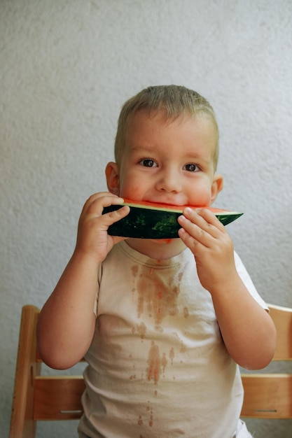 Cute child eating red juicy watermelon