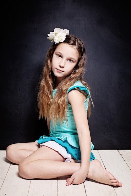 Cute Child Girl. Portrait of Young Teen on Dark Background