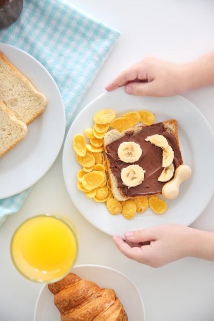 Cute child having breakfast at home