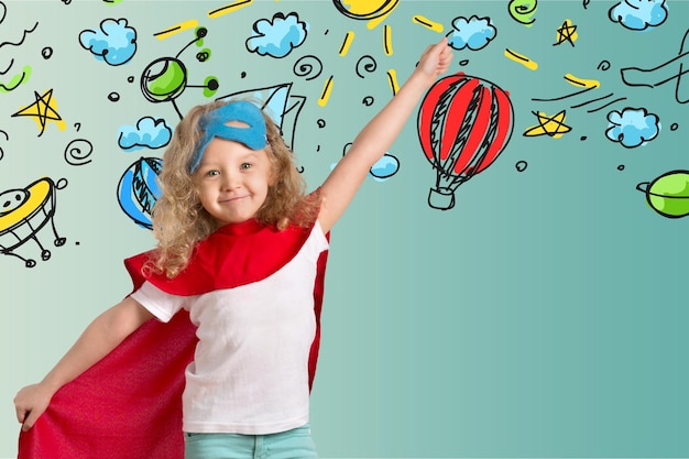 Cute Child in superhero costume on background
