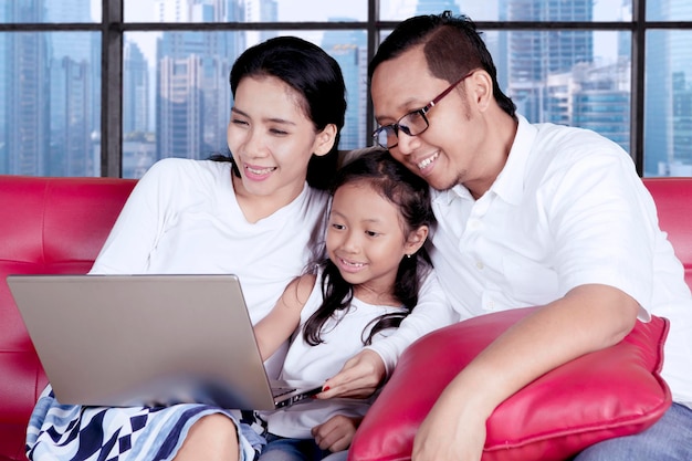 Cute child with parents using a laptop