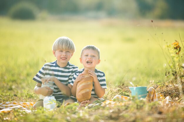 Cute children drinking milk and eating bread