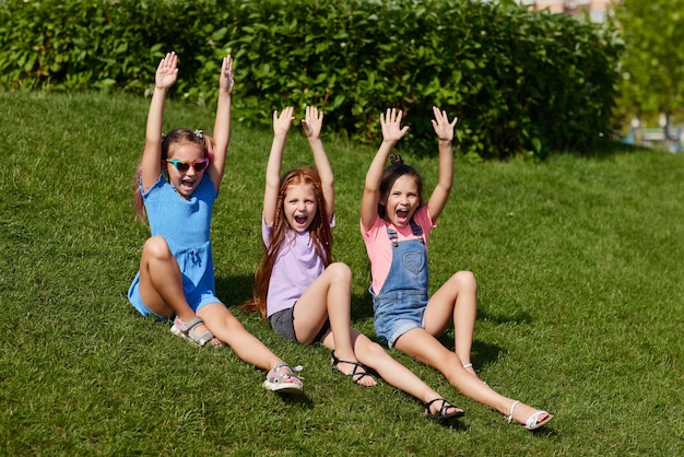 Cute children girls playing together in the park