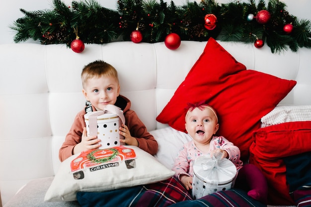 Cute children laying in bed on Christmas