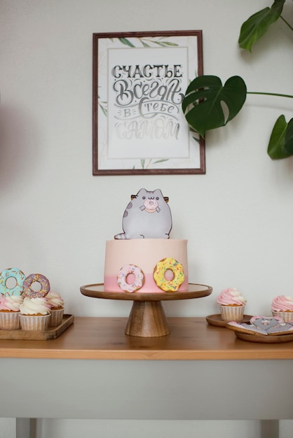 Cute children's cake with donuts and a cat, poster happiness is always in you
