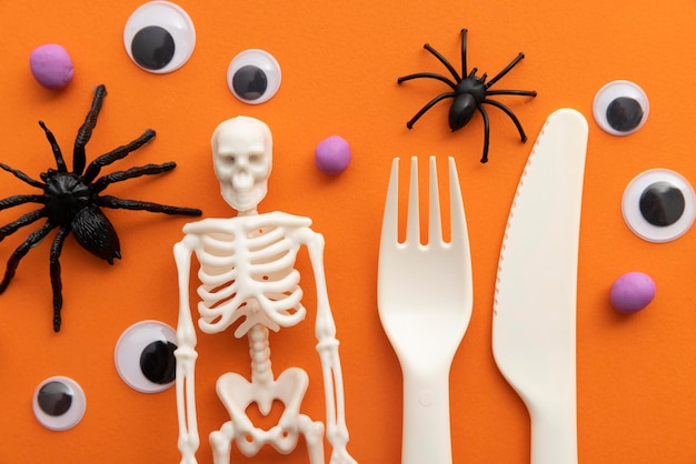 Cute childrens halloween party background with cutlery skeleton spiders and eyeballs