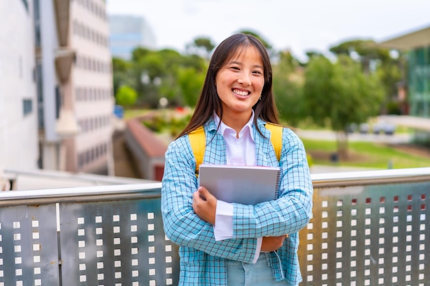 Cute chinese university student smiling at camera